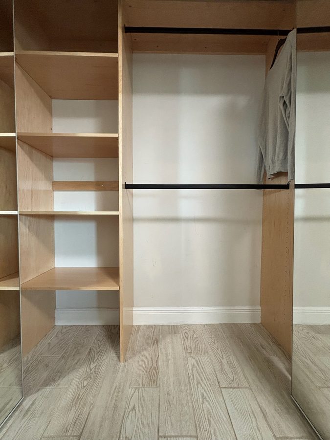 Custom closet build-out with shelving and hanging rods