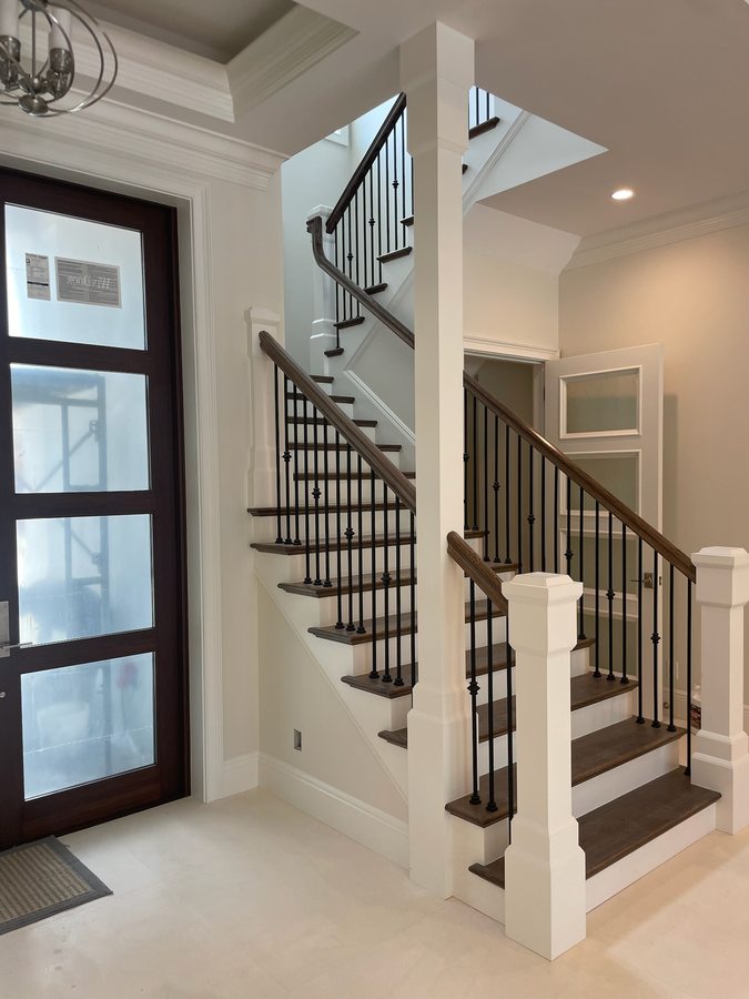 Grand finished staircase with iron balusters