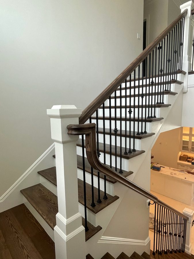 Custom staircase with iron balusters and wood treads